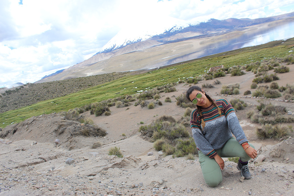 Gaby posing in front of a lake and mountains in Chile
