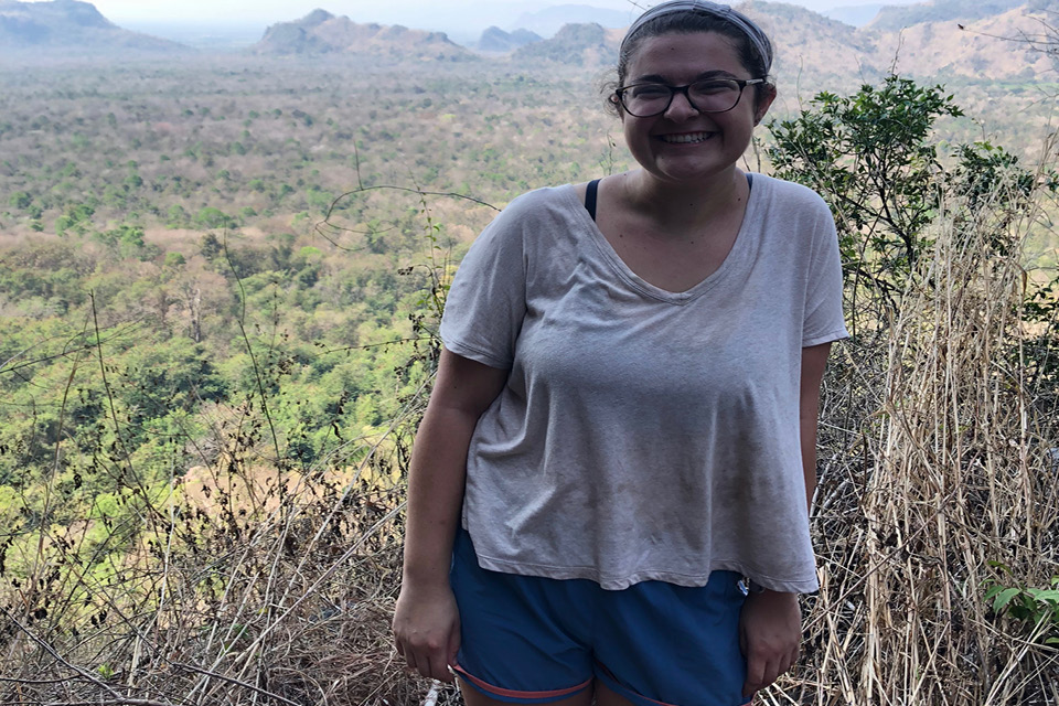 Julia standing in front of a mountain range