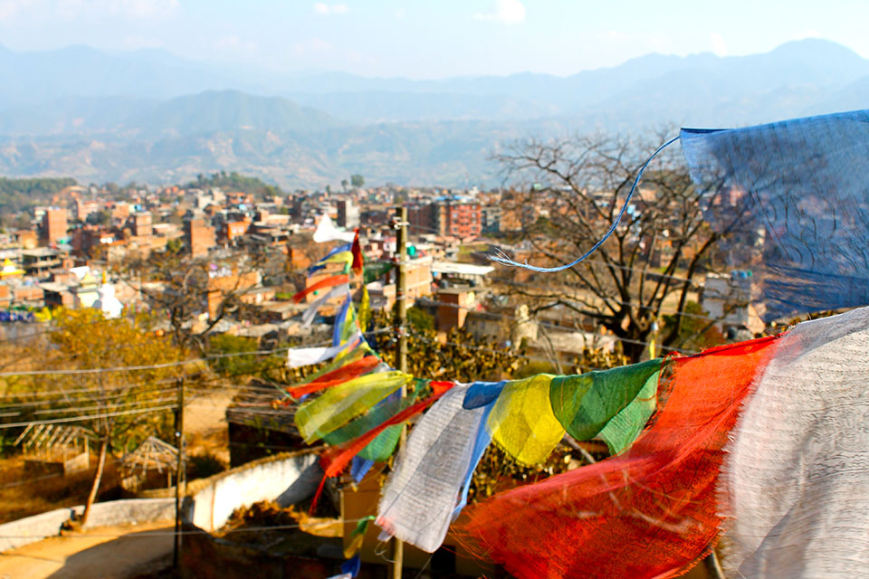 Prayer flags fly over a city in Nepal