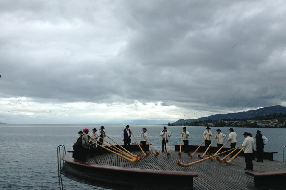 A group of men blowing alphorns in Switzerland