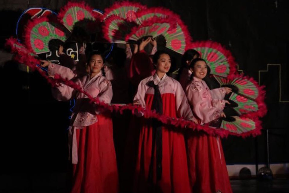 Korean students perform a fan dance