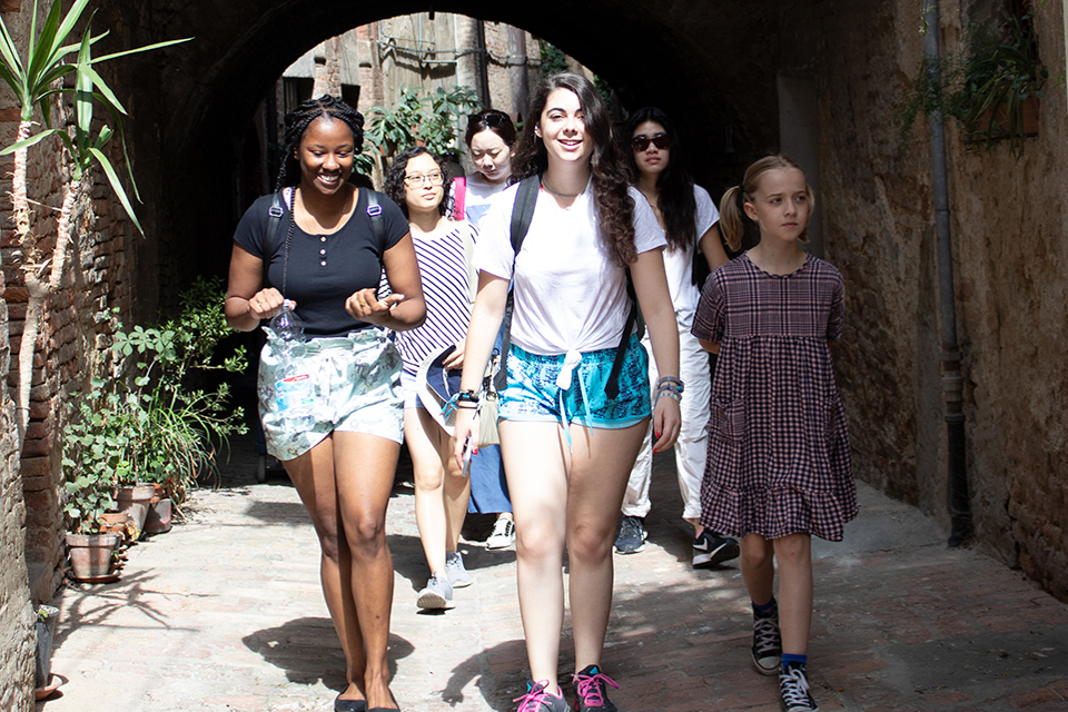 Students walking down an alleyway in Siena