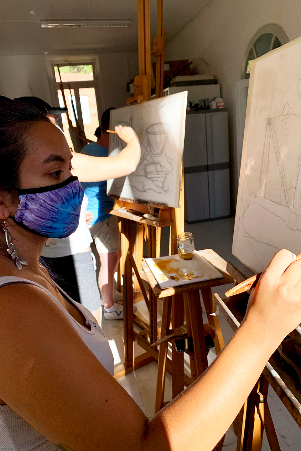 A Brandeis student painting in the studio at the Siena Art Institute