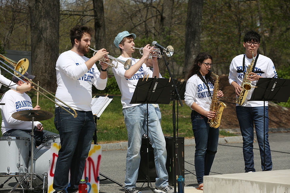 Instrumentalists playing music, wearing Brandeis University shirts