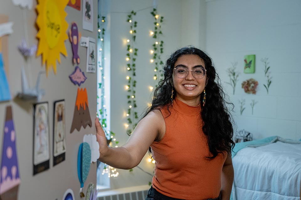 Student opening the door to their residence hall room