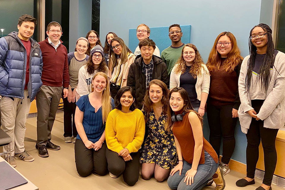 Group of students and staff smiling