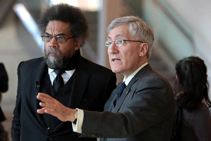 Robert George, right, gestures during panel discussion with Cornel West, left