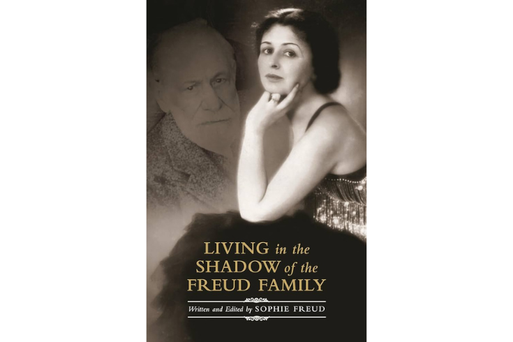 Book cover of "Living in the Shadow of the Freud Family." Picture of Sophie Freud looking off into the distance with Sigmund Freud floating as a shadow behind her.