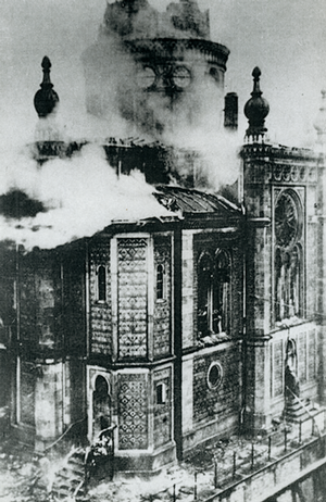Black and white photo of a building in flames