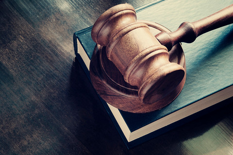 Legal gavel on top of a wood table