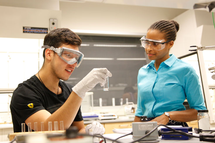 Chemistry lecturer Kristin Mascall works with a student in the lab