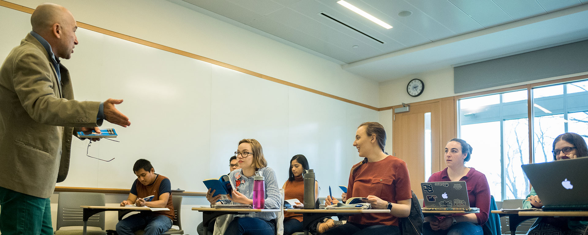 Professor Fernando Rosenberg speaks to a group of students in a classroom