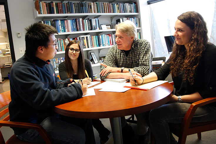 Prof. Jefferson speaking with students in an office
