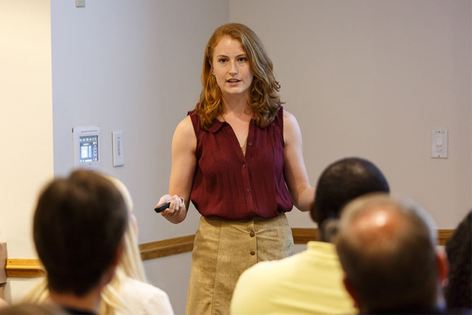 An Education program graduate student presents research in front of a group