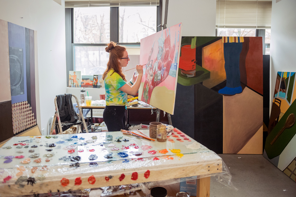 Honors student painting in her studio in Epstein