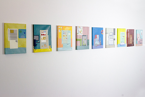 This is a series of nine paintings all ten-inches tall by six-inches wide hung in a horizontal line. Each is a different image of a freezer-refrigerator in a room with one or both of its doors open showing the contents. In some cases, the freezer-refrigerators are full and in others they are empty. The paintings play with color, pattern, and composition in a whimsical manner.