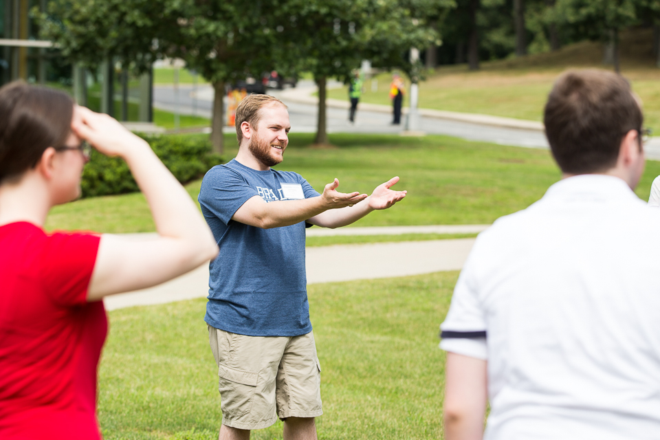 orientation leader leads an activity outside admissions building