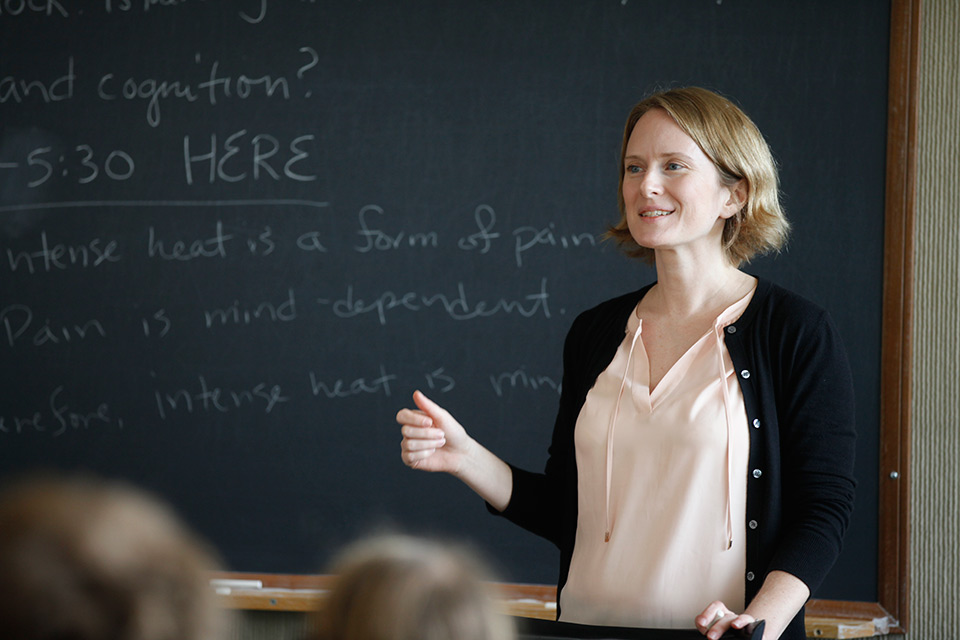 philosophy professor in front of chalkboard