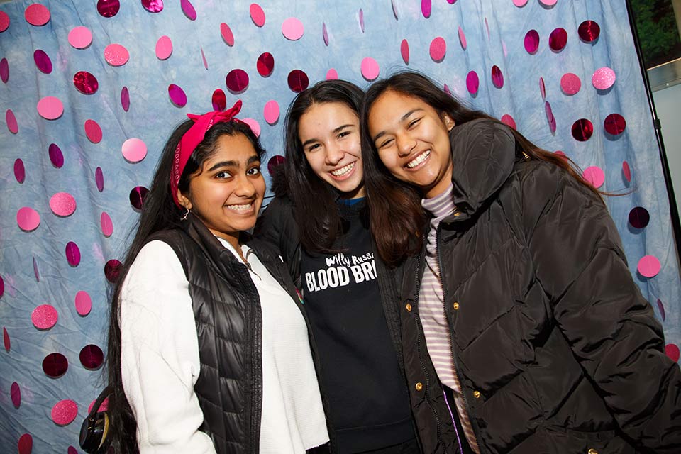 Three students posing at a Kindness Day event