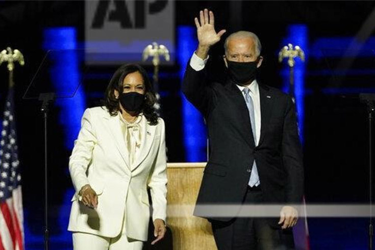 Kamala Harris and Joe Biden victoriously greet supporters