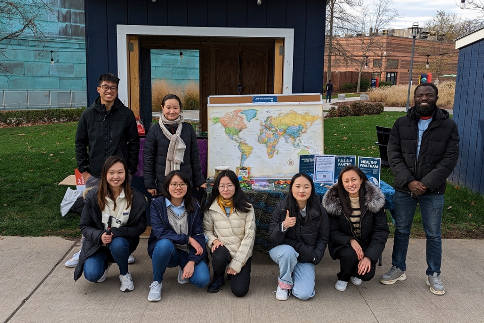 Brandeis students in front of Brandeis Blue Booths for International Candy Tasting event