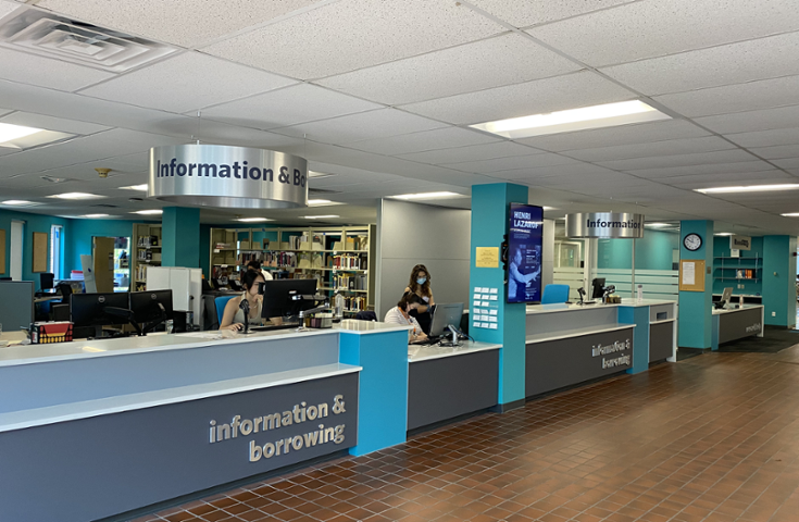 Refurbished and new-looking Circulation and Research Help point desks on the main floor of the Library