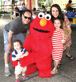 Family members with Elmo at Sesame Place.