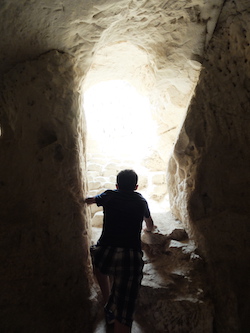Boy emerging from cave