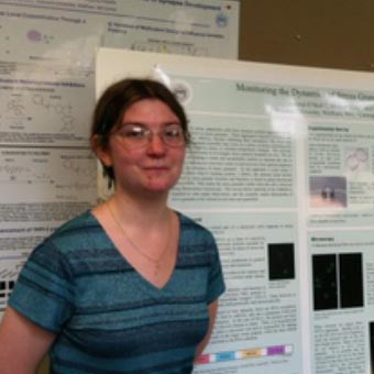 Lauren O'Neil in front of her poster at the Brandeis Symposium