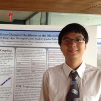 Adam Wang standing in front of his poster.