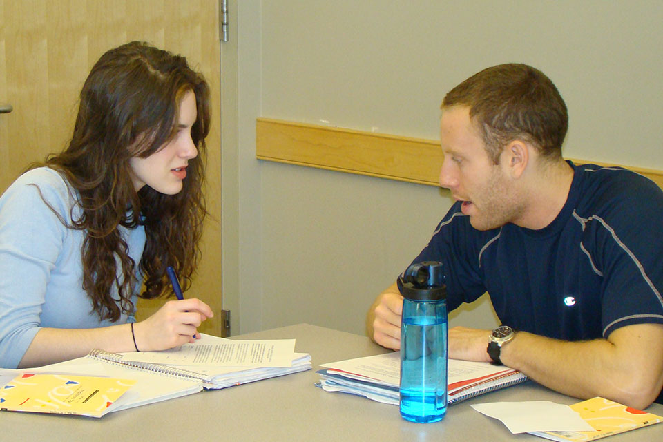 Two students working at table