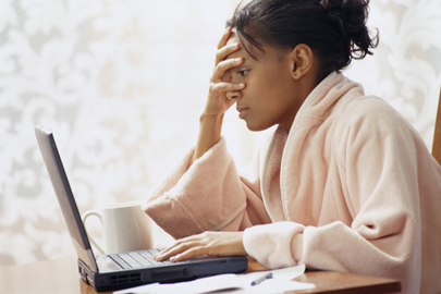 Woman at computer in distress looking at screen