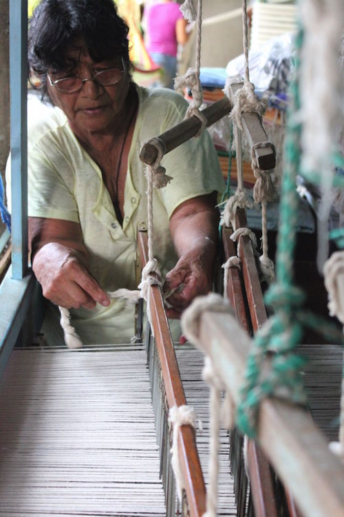 A back strap loom in action