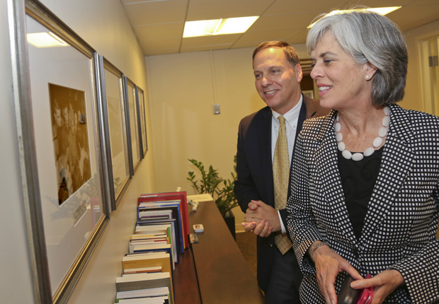 Brandeis President Ron Liebowitz and Congresswoman Katherine Clark look at a photo of Eleanor Roosevelt at Brandeis.