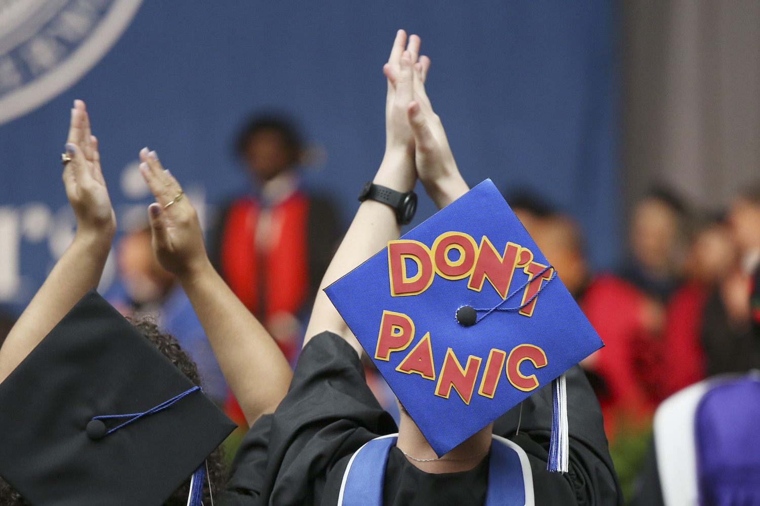 A mortarboard decorated with red letters that read "Don't Panic"