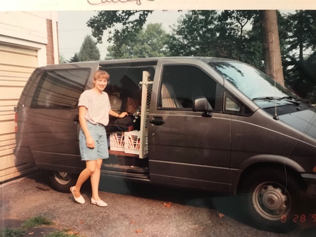 Wendy Cadge pulling boxes from an old minivan