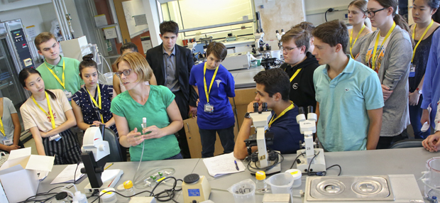 Students at the 2018 Global Youth Summit on the Future of medicine in the lab with Melissa Kosinski-Collins, professor of Biology