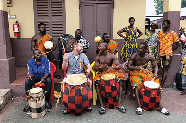 Ben Pauding plays with drummers in Ghana