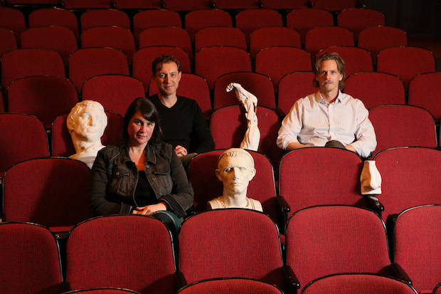 Cameron Anderson, Dmitry Troyanovsky and Joel Christensen sit in theater seats with ancient greek busts