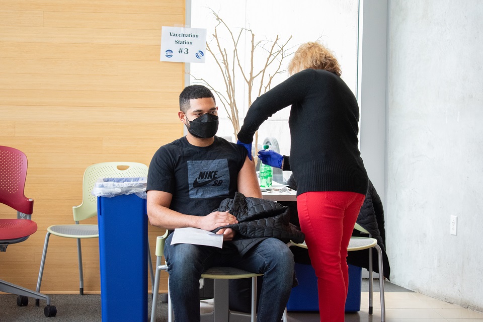 student receives a vaccine