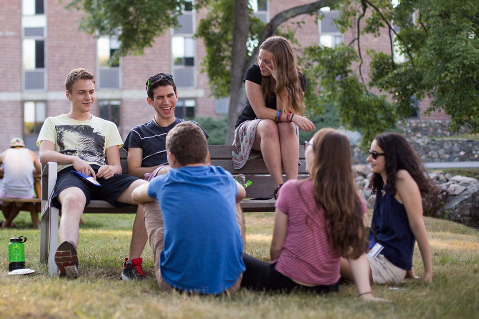 A group of students sitting outside laughing