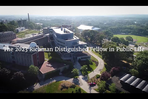 Aerial view of the Brandeis campus with text that reads: "The 2023 Richman Distinguished Fellow in Public Life"