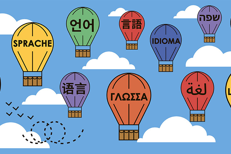  illustration of hot-air balloons, each featuring a different language.