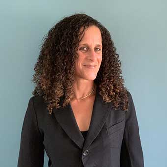 Faculty photo of Sarah Stein, against a blue background