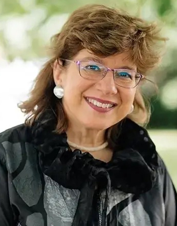 headshot of Susannah Heschel in front of a blurry, green outdoor scene