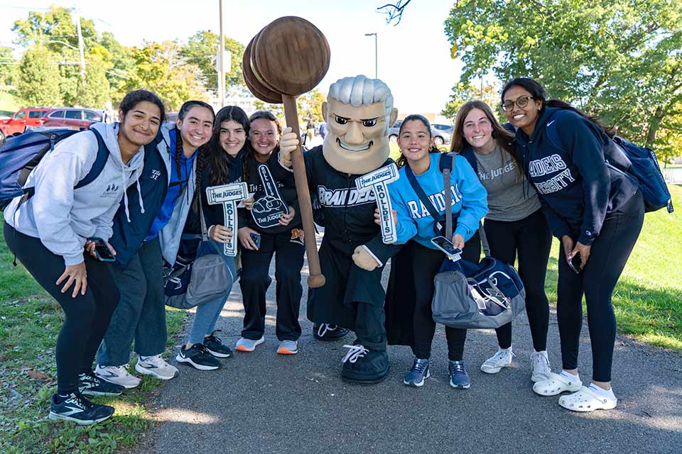 Group of students posing with the Judge mascot