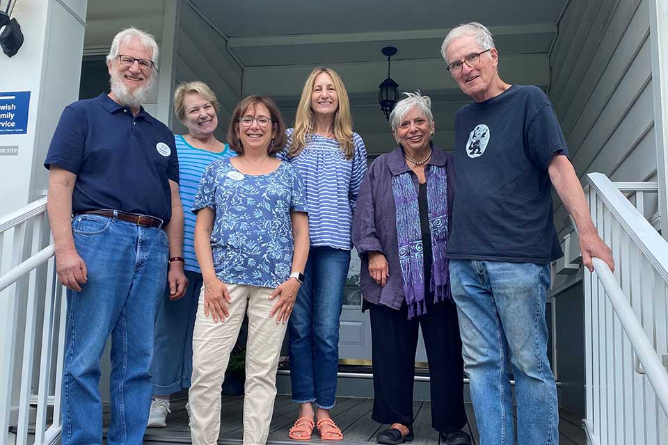 People pose on a porch