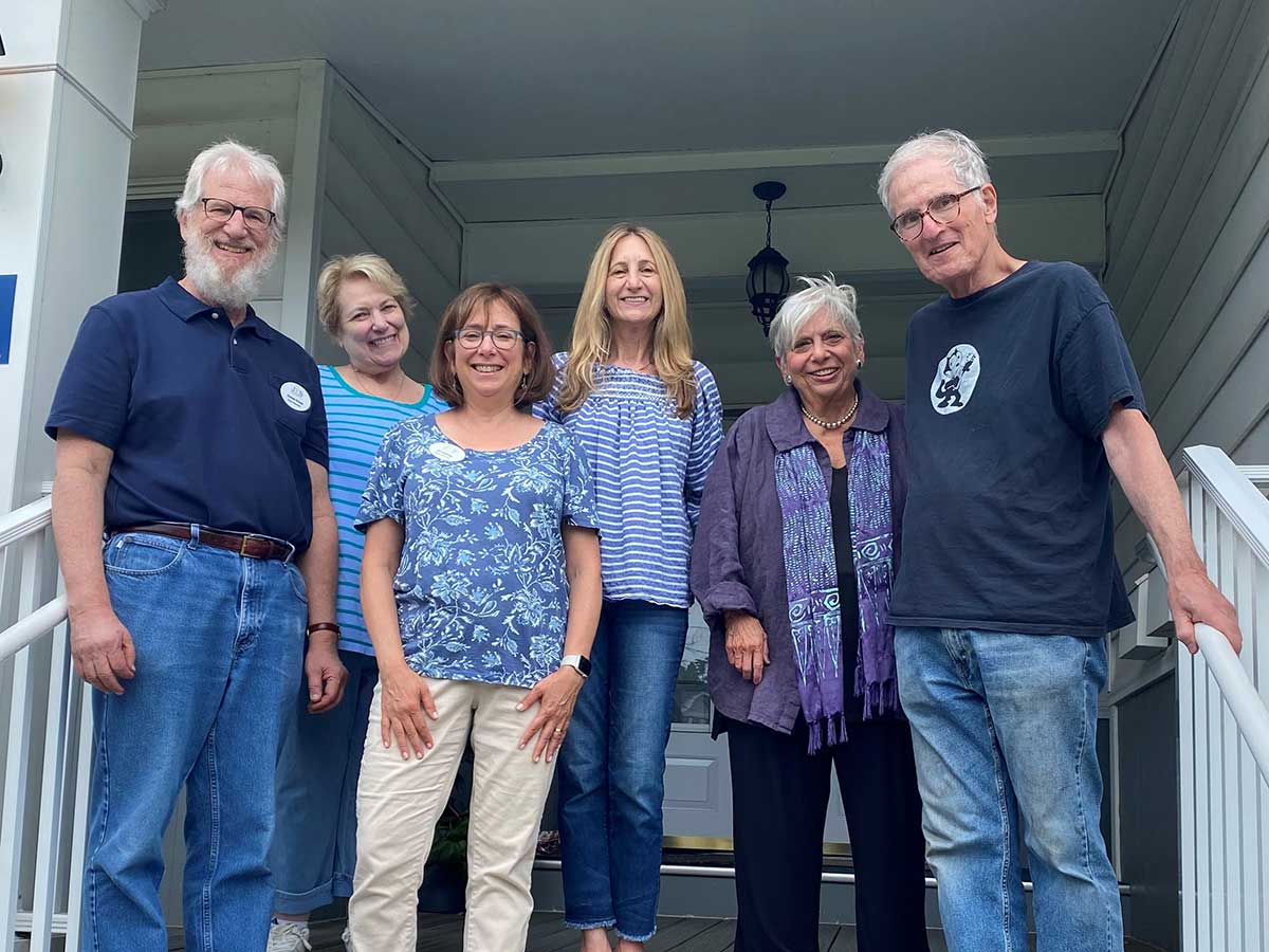 A group of volunteers stand on a patio staircase at the Jewish Family Service of Somerset, Hunterdon and Warren counties.