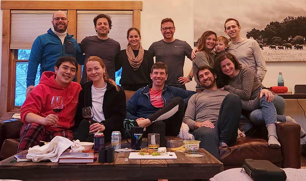 12 people smiling in a ski lodge