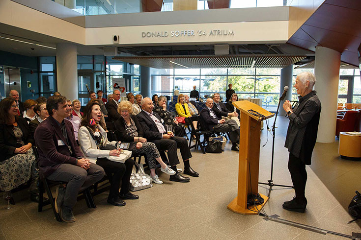 A person speaks to a group of audience members